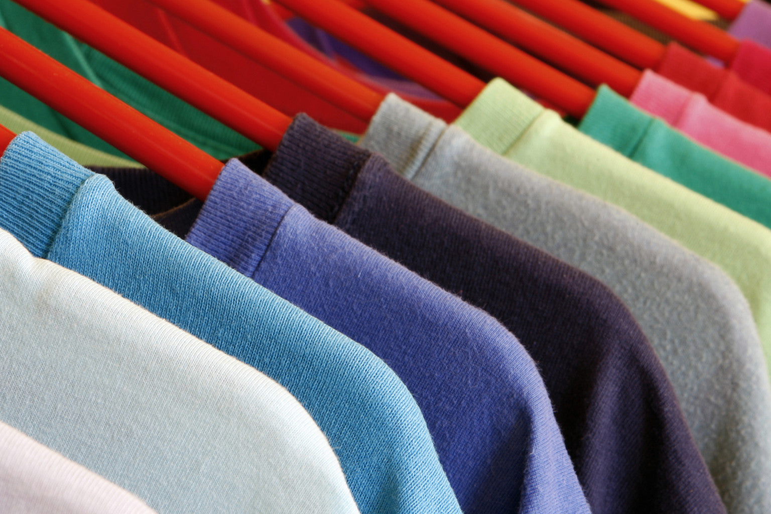 Colorful blank T-shirts on a rack, from the original CRE8 website